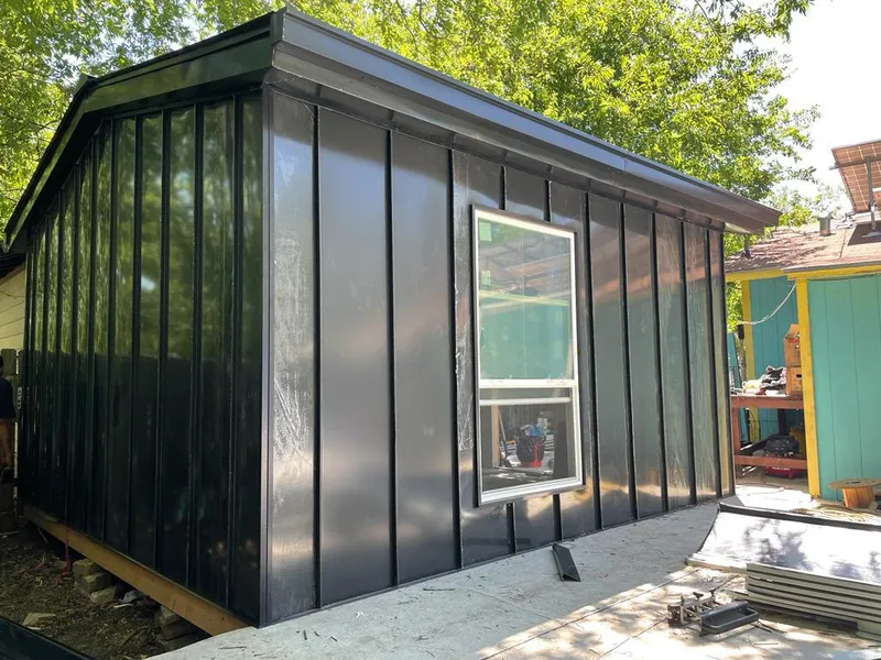 Black standing seam metal wall panels for Roof Inspection in St. Francis